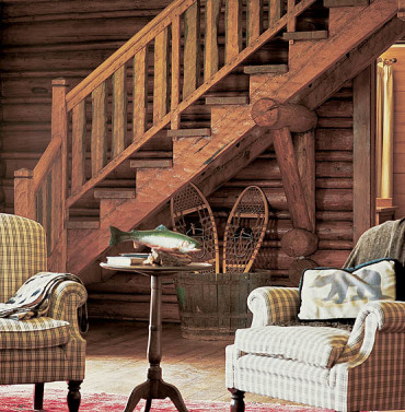 The architects refurbished the main log cabin into a cozy country retreat. The walls are interior logs stained a warm golden amber.